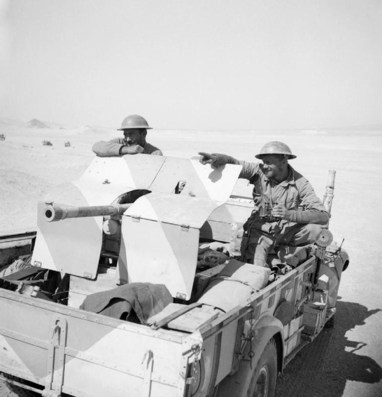 A_lorry_mounted_anti-tank_gun_in_the_Western_Desert_being_manned_by_New_Zealand_LRDG_troops_as_they_return_to_Cairo,_27_March_1941._E2301